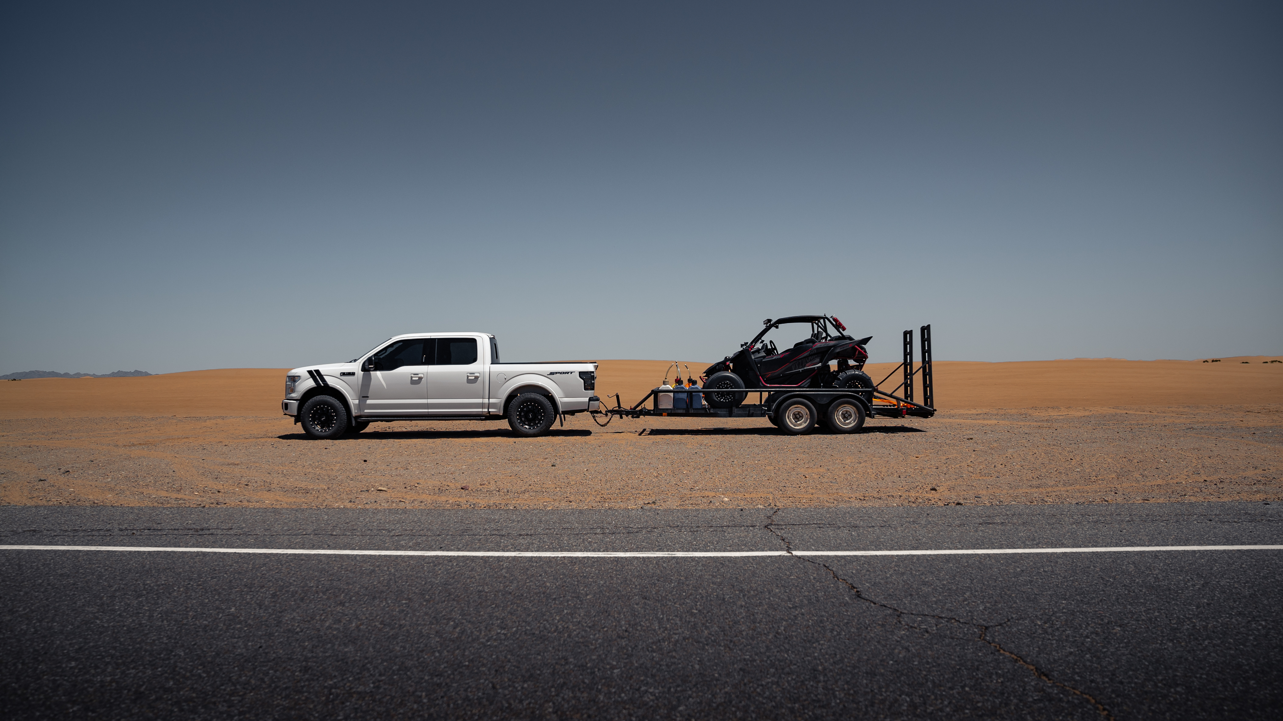 Truck Pulling a UTV Trailer in Desert
